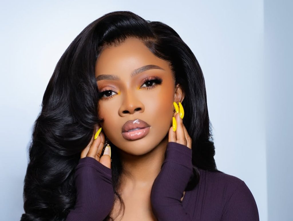 Wait, Did Toke Makinwa Just Win Best Dressed… for a Chill Day Out? oke Makinwa’s plum ribbed top, yellow acrylics, and old-Hollywood curls