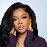 oke Makinwa’s plum ribbed top, yellow acrylics, and old-Hollywood curls