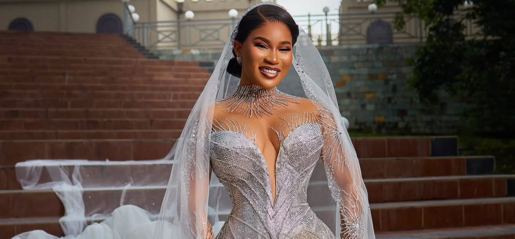 Diiadem steals the spotlight in a Dramatic Custom Sima Brew Bridal Gown.